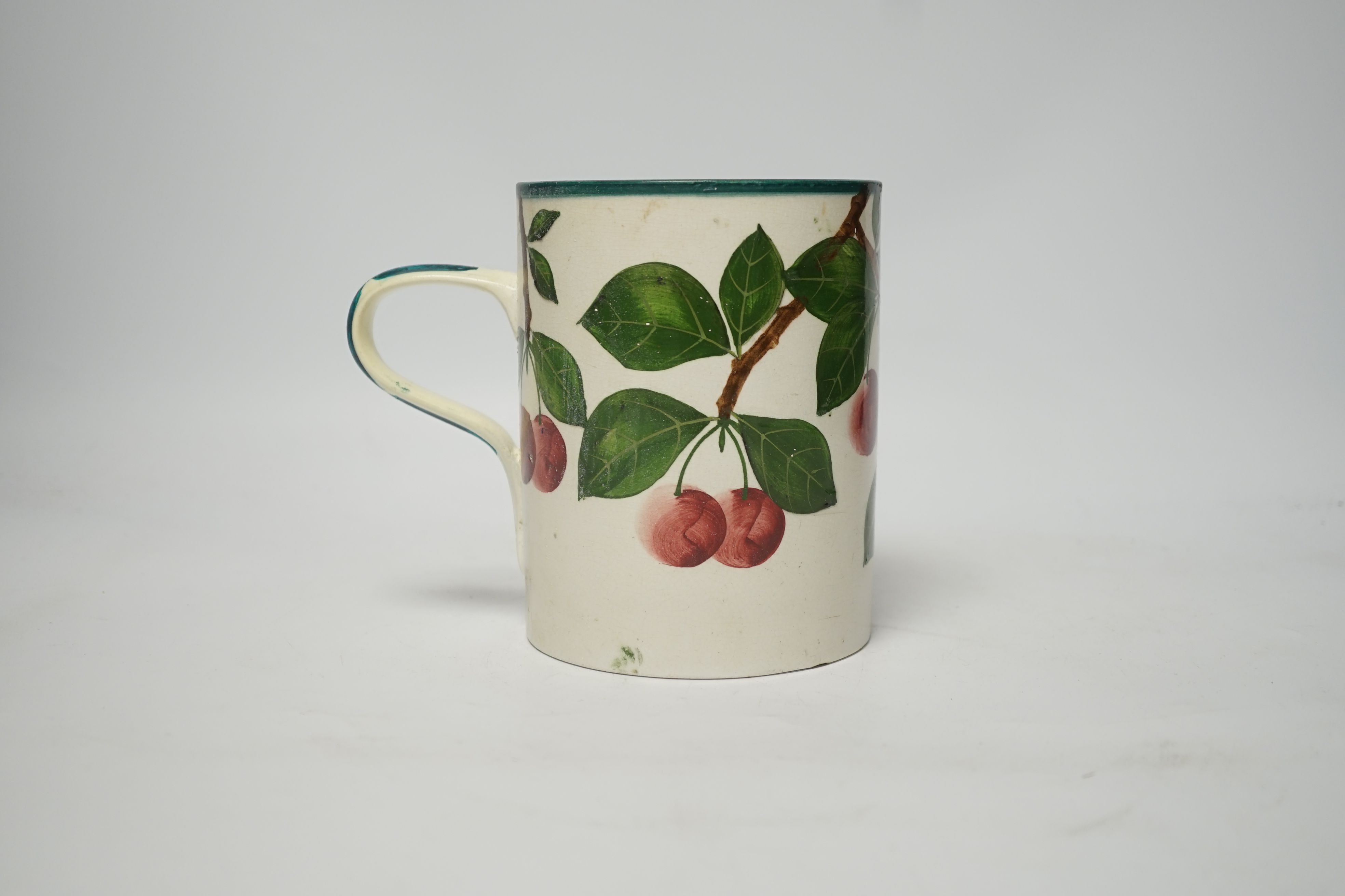A Wemyss mug with cherry decoration (restored a.f.), 14cm high